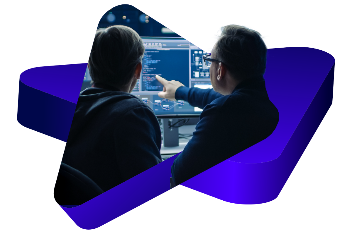 Image of two developers pointing at a screen and cropped by 3d triangle shapes