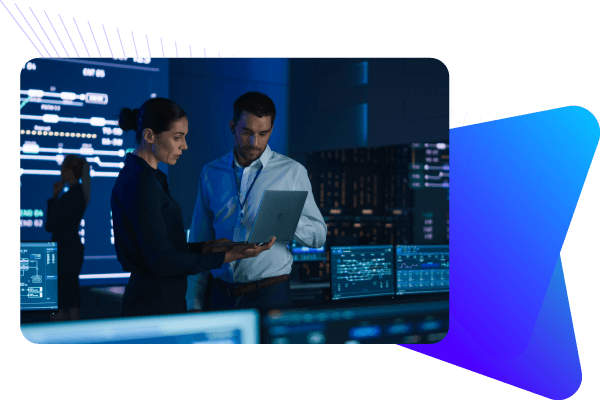 Professional employees examining laptop in control room with servers and many screens.