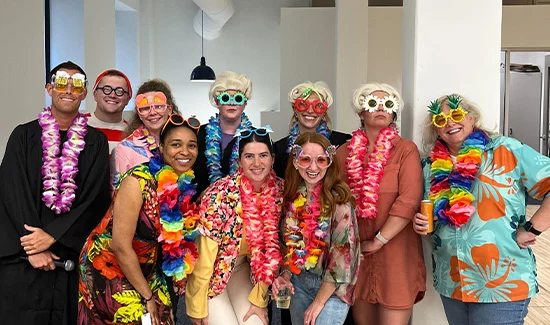 Perforce employeess wearing hawaiian shirts and brightly colored glasses