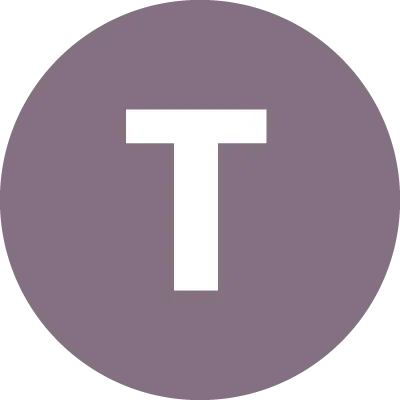 The letter T in a circle.